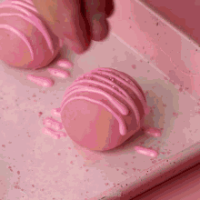 a heart shaped box filled with pink and white truffles