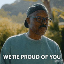 an older man wearing glasses and a hat says we 're proud of you