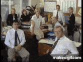 a group of people in an office with a bbc logo on the corner