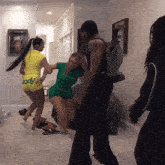 a man and two women are dancing in a room with a jersey on the wall that says james
