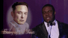 a man in a tuxedo speaking into a microphone next to a picture of elon musk