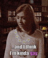 a woman is wearing a pink sweater and says " and i think i 'm kinda gay "