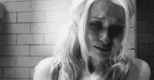 a black and white photo of a woman with a black eye .