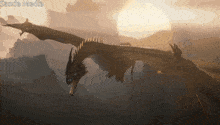 a dragon is flying in the sky with the words sands media written below it