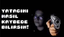 a hand holding a gun with the words yatagini nasil kaybede bilirsin