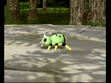 a green and yellow cartoon spider is walking on a concrete surface