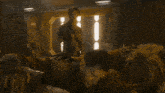 a man is laying on another man 's chest in a room