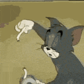 tom from tom and jerry is holding a roll of tape