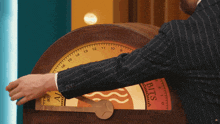 a man in a suit is playing a game with a clock that says bits