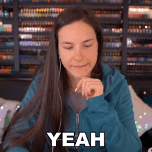 a woman wearing headphones says " yeah " while looking down