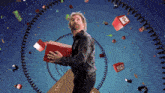 a man is holding a red box with a number 21 on it
