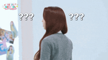 a girl with long red hair is standing in front of a wall that has a picture of a girl and the words " new school " on it