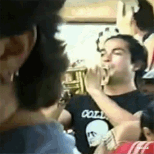 a man wearing a black shirt that says coll