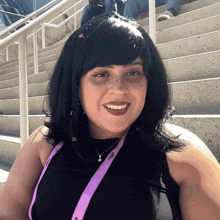 a woman wearing a black top and a lanyard that says jcpenney