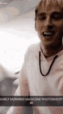 a man in a pink shirt is smiling in an airplane with the caption early morning magazine photoshoot