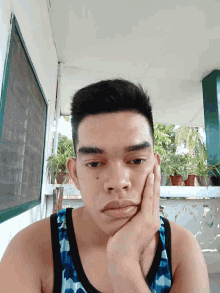 a man with his hand on his chin looks down at something