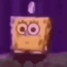 a blurry picture of a spongebob squarepants character with a candle in his eyes .