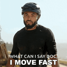 a man with a beard wearing a helmet says what can i say doc i move fast