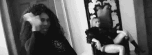 a woman is standing in front of a mirror in a room .
