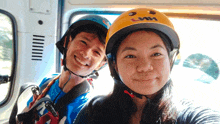 a woman wearing a helmet that says lmh smiles next to a man
