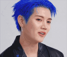 a close up of a person with blue hair