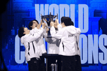 a group of people holding up a trophy with the word world champions behind them
