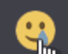 a yellow smiley face with tears coming out of its eyes and a hand pointing at it .