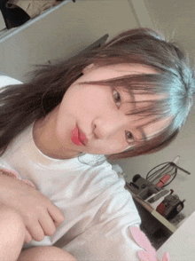 a girl with long hair is taking a selfie in front of the mirror