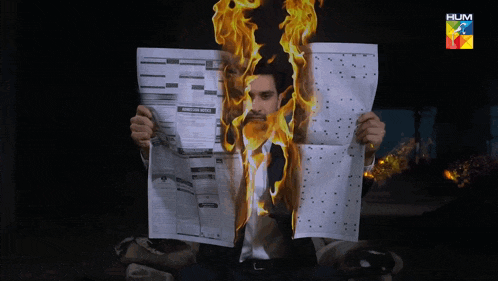 a man is holding a newspaper that says 