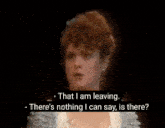 a woman with red hair is singing on stage in a dark room .