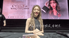 a woman is sitting in front of a large screen that says orsi & your heartbeat