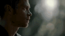 a close up of a man 's face with a light behind him