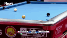 a pool table with inews written on the top