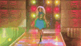 a woman in a blue and green dress is walking down a runway