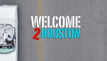 a white car is driving down a road with the words welcome 2 houston above it