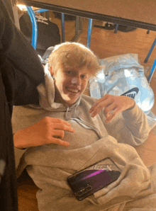 a young man laying on the floor with a nike bag behind him