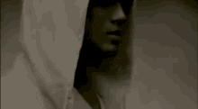 a close up of a person wearing a white hooded sweatshirt