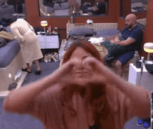 a woman making a heart shape with her hands