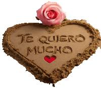 a heart made out of sand with the words te quiero mucho written in it