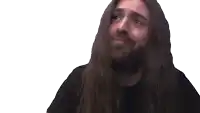 a man with long hair and a beard holds his fist up