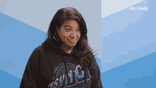 a woman wearing a black hoodie that says miami is smiling
