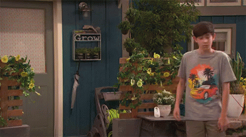 A person wearing shorts and a t-shirt turning to sprint, but a lined hook caught on the back of their shirt collar whiplashes them back.