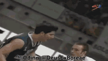 a basketball player with the number 18 on his jersey is trying to block another player