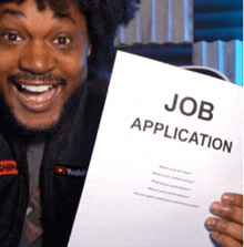a man is holding up a job application