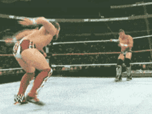 two men are wrestling in a ring with the word nbc on the bottom left