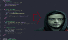a man in a black hoodie is standing in front of a computer screen with a red arrow pointing to it