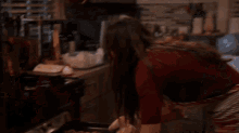 a woman is standing in a kitchen with a tray of cookies on the counter .