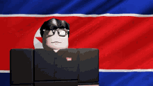 a man in a black shirt with a red and blue flag behind him with the letter e on it