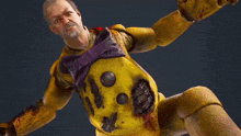 a man with a beard is wearing a yellow and purple shirt