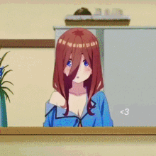 a girl with red hair and blue eyes is standing in front of a fridge .